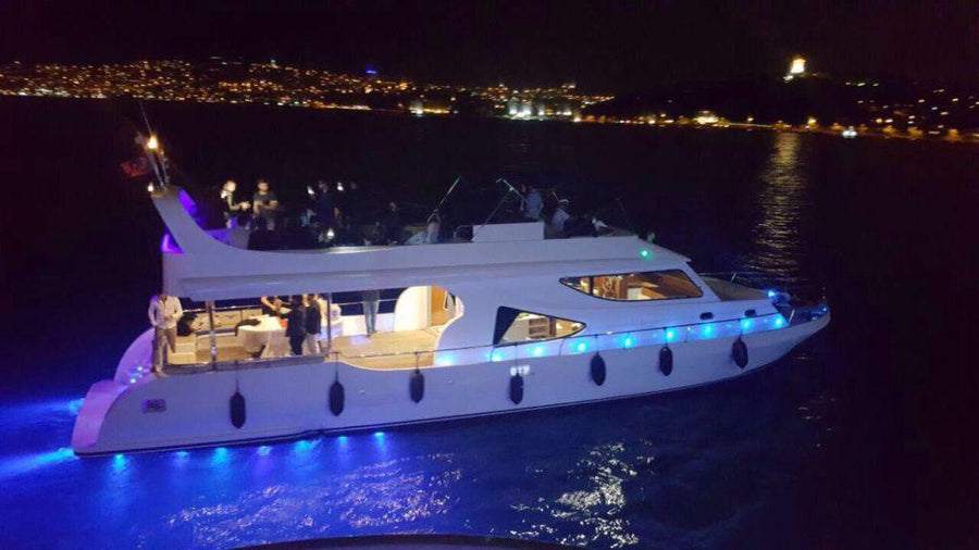 Yacht illuminated at dusk for romantic Istanbul cruise.