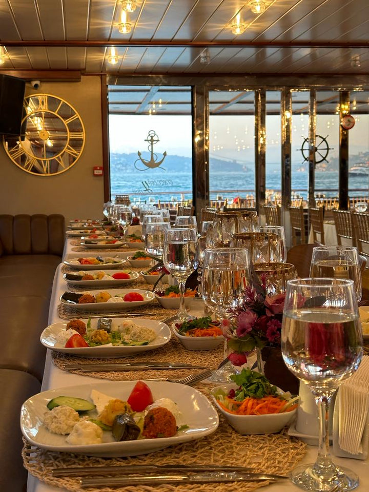 Elegant dining setup aboard LUXURY ÇNG with panoramic views of the Istanbul coastline, accommodating 