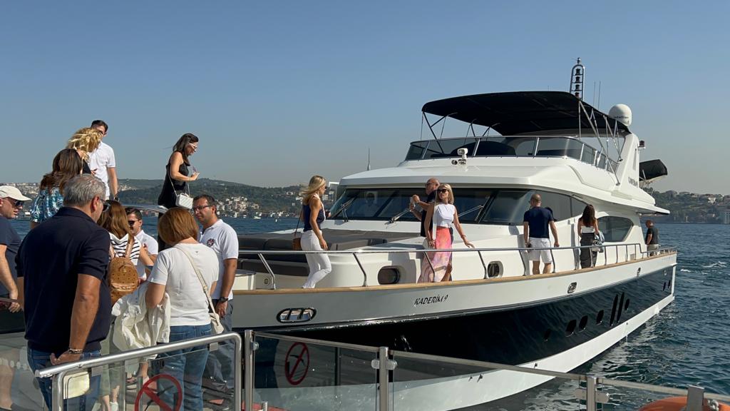 Tourists watching dolphins from yacht on Istanbul waters.