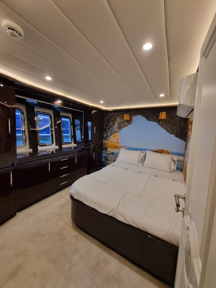 Yacht bedroom with Istanbul coastline view.