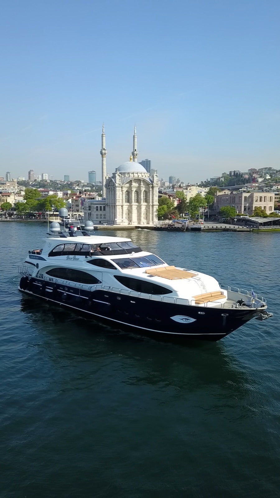 Yacht cruising under the Bosphorus Bridge, Istanbul